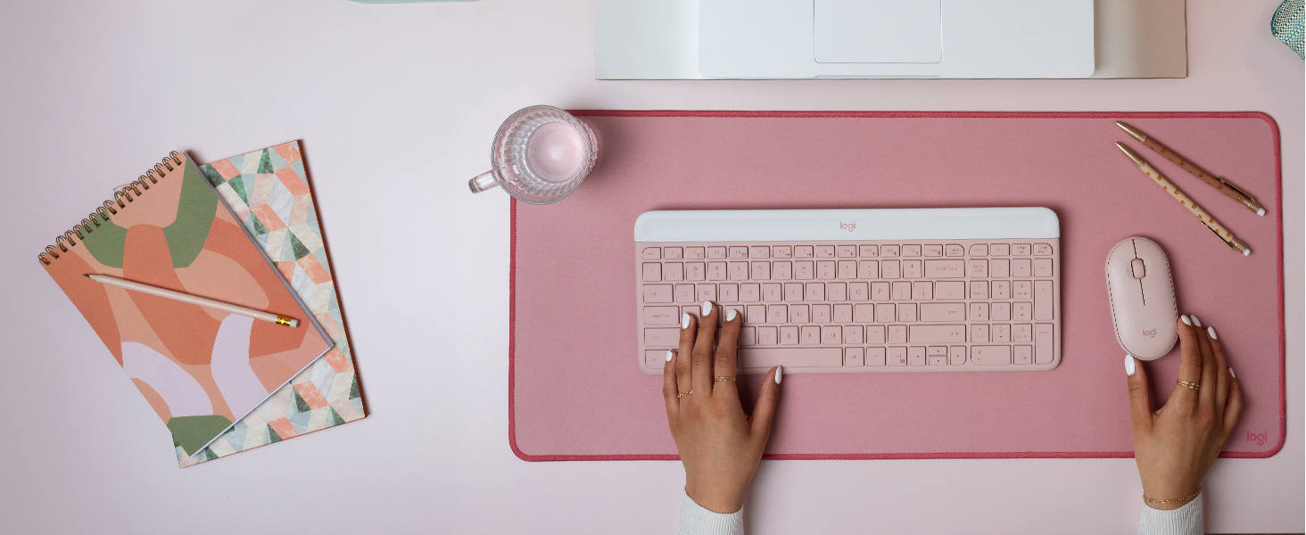 a woman using mk470 slim wireless mouse and keyboard pink combo, desk mat large mouse dark rose pad