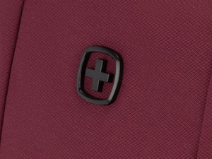 Close-up of a Swiss cross logo badge on 600D ripstop polyester fabric of a laptop backpack