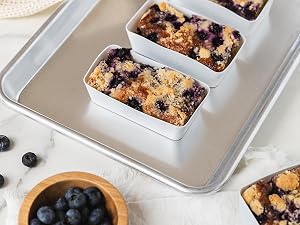 Rectangle silicone baking cup with a blueberry crumble on a baking sheet
