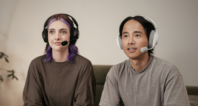 A woman and a man wearing headsets and gaming together
