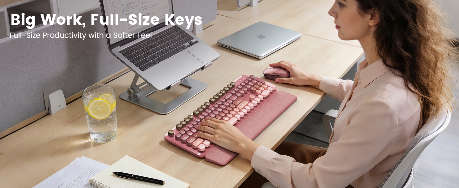 Pink wireless keyboard mouse combo on desk with laptop stand wrist rest for daily work