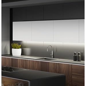 Kitchen with white lighting under cabinets.