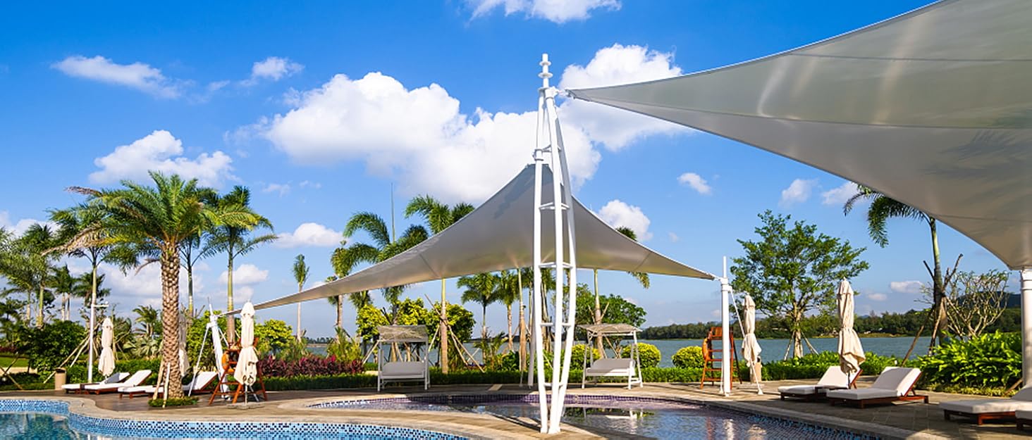 a large white sail over a pool