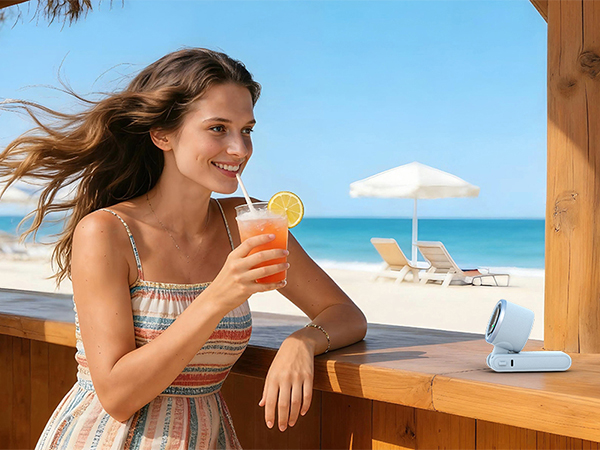 Relaxing vacation essentials blue portable fan on table quiet personal fan for summer beach bar