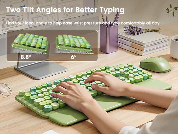 Hands typing on green keyboard with wrist rest, showing two adjustable tilt angles on desk
