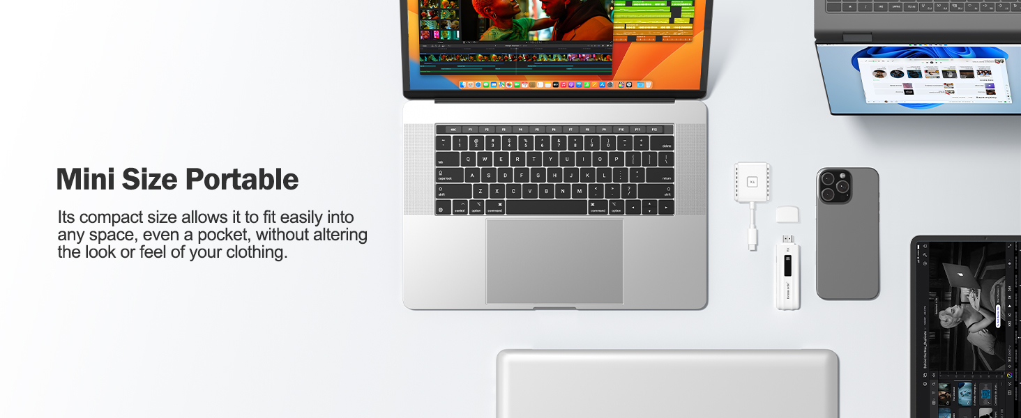 Laptop workspace setup with portable monitor, keyboard, smartphone, and accessories arranged on white surface, highlighting mobile workstation capabilities.