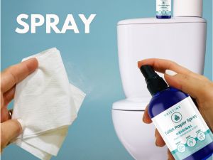 hand spraying Pristine toilet paper spray on toilet paper in bathroom
