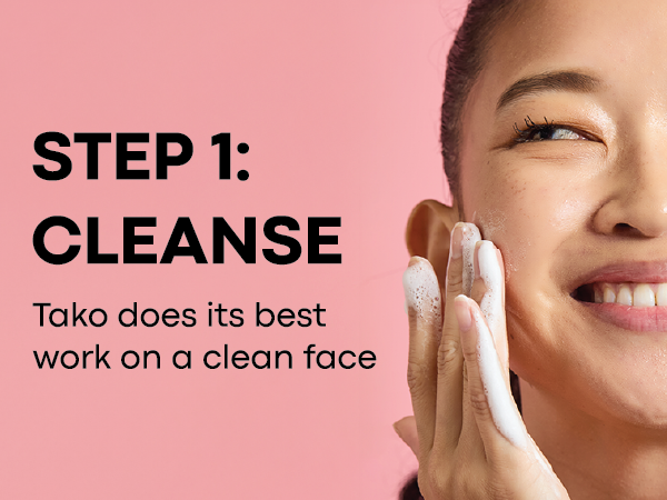 Step 1 – Cleanse: smiling model washing face with foamy cleanser on a pink background