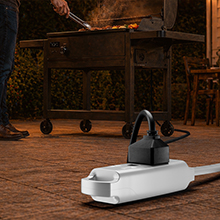 Maximm durable outdoor extension cable powering a backyard patio grill.