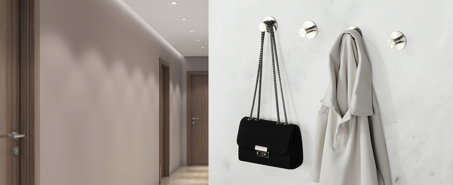 Minimalist hallway interior with wall hooks holding a black quilted handbag with chain strap and light gray bathrobe against beige walls.