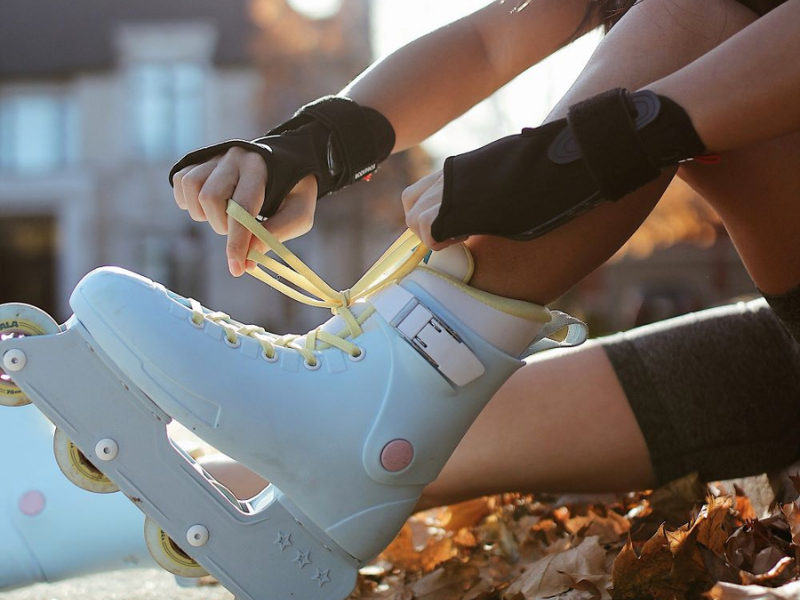 Woman putting on rollerblades