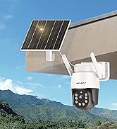 Solar-powered security camera mounted on building exterior with solar panel above it, white housing with dark lens turret, mountainous landscape visible in background.