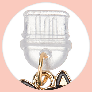 Clear plastic bottle-shaped keychain or charm with gold-tone metal attachments against pink background.