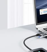 Laptop with external display port connecting to a cable. Screen shows Google Chrome browser window. White background with faint grid lines visible.