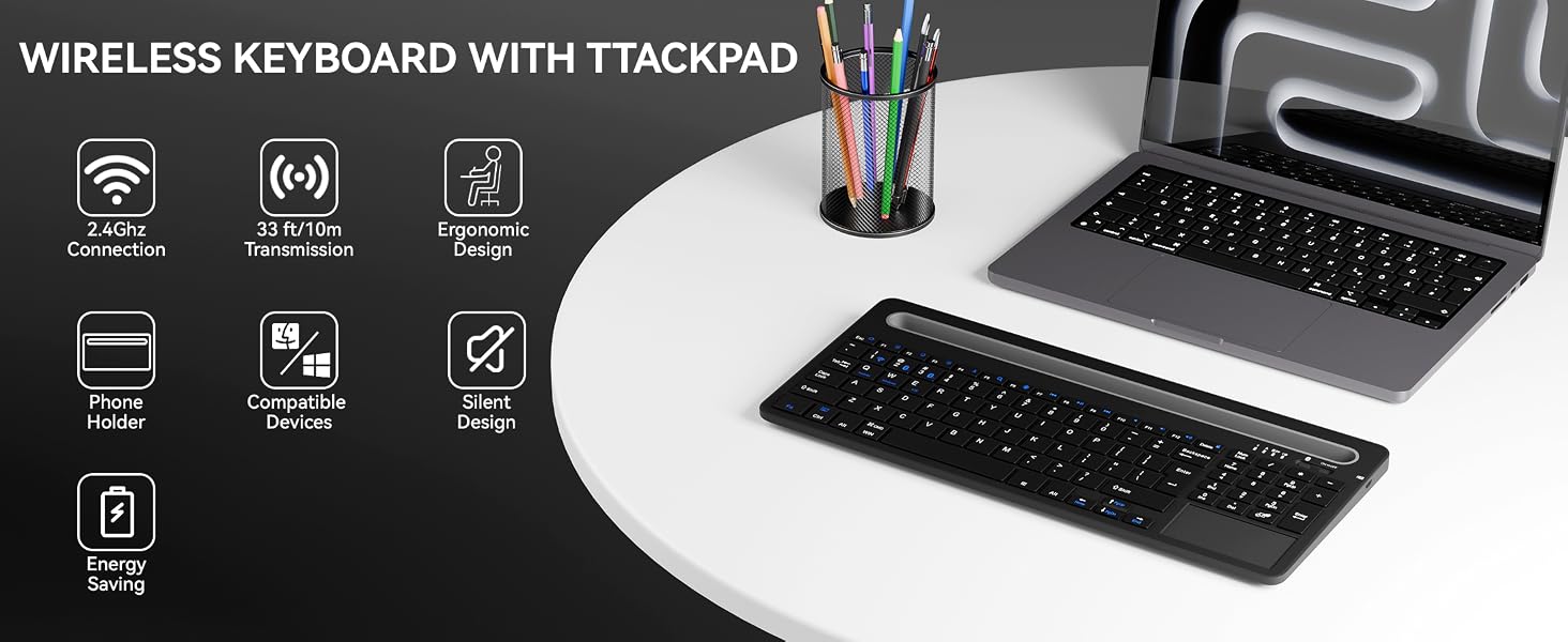 Wireless keyboard with trackpad and phone holder on desk next to laptop for home office use