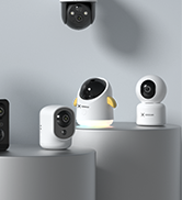 Set of white spherical security cameras with modern minimalist design, displayed on grey surface.