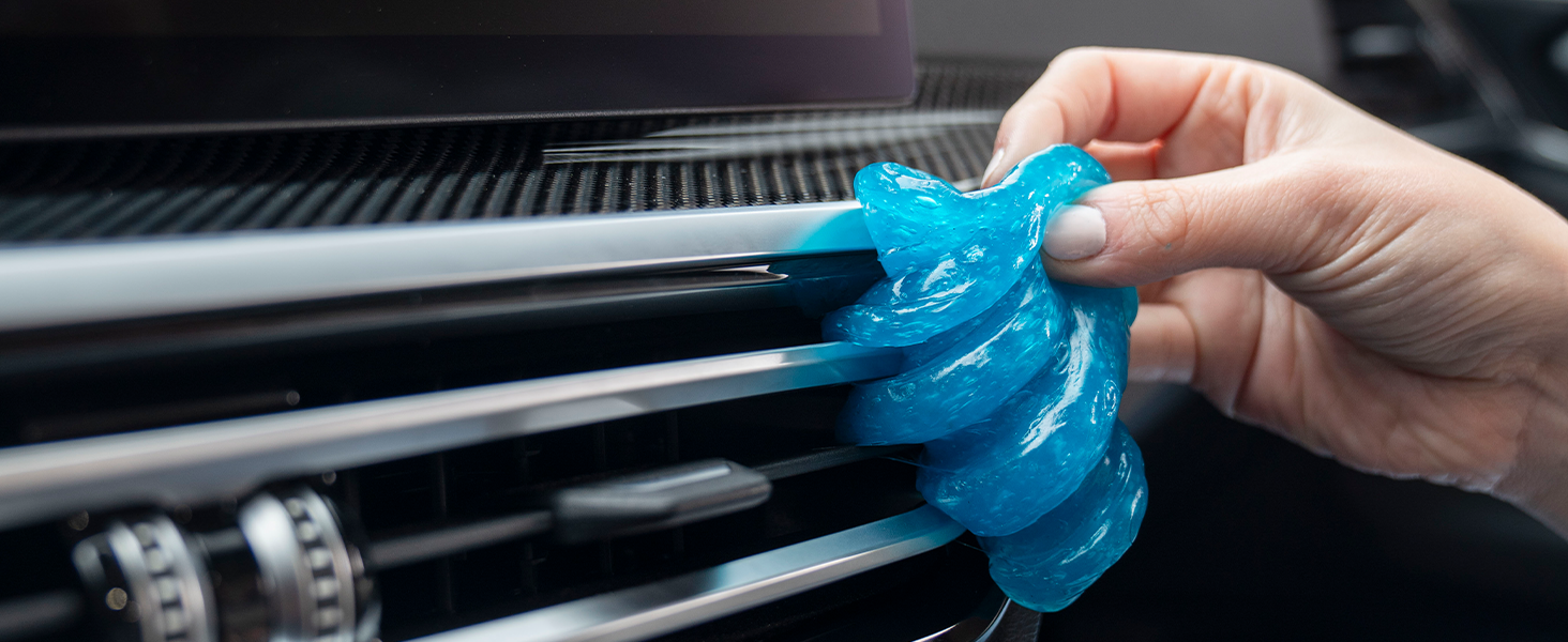 Car cleaning gel lifting dust from tight vents and dashboard crevices for interior detailing