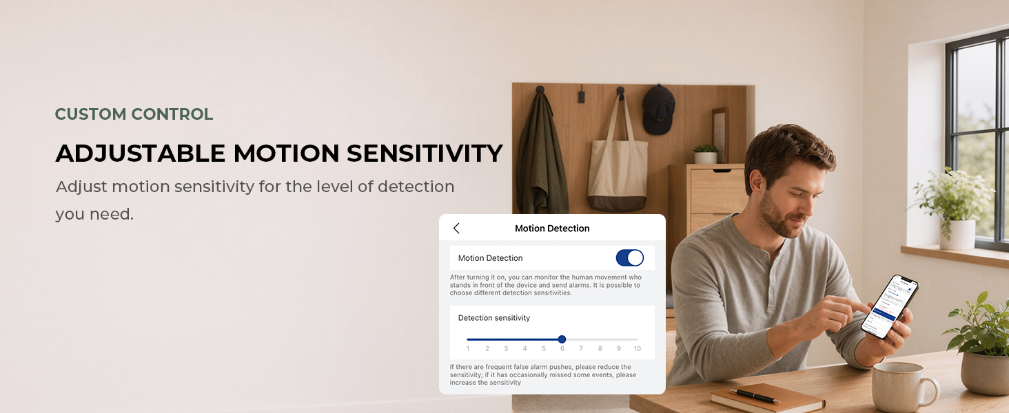 Person adjusts camera motion sensitivity in the mobile app on a smartphone.