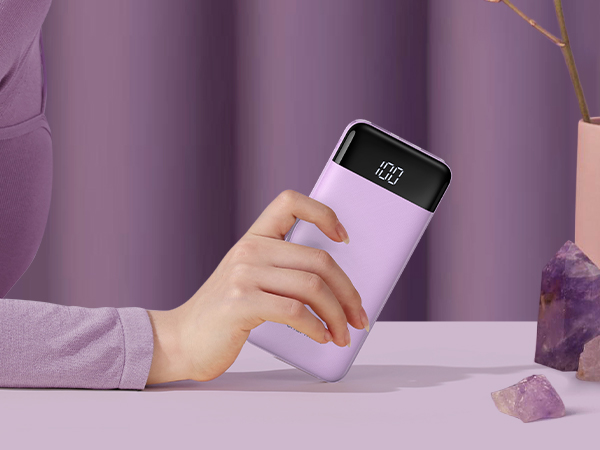a woman holding a charger in her hand