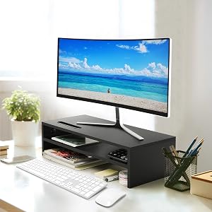 a desk with a monitor and keyboard on it.