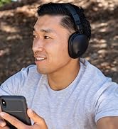 Model wearing Bluetooth over-ear wireless headphones