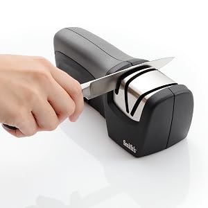 pocket knife being sharpening in handheld electric knife sharpener manual sharpening