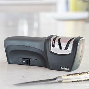 handheld sharpener displayed with tools and knives electric and manual sharpening slots