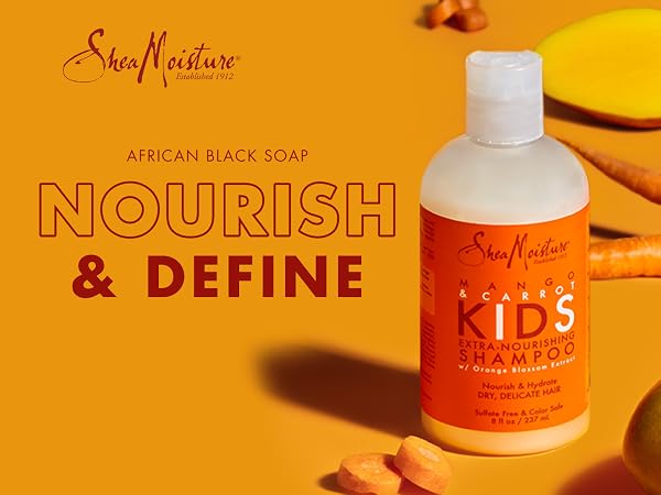 SheaMoisture Kids Shampoo bottle with carrots and mango on an orange background.