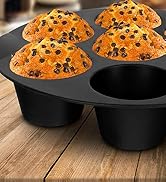 silicone muffin pan with freshly baked muffins placed on wooden table in bright kitchen