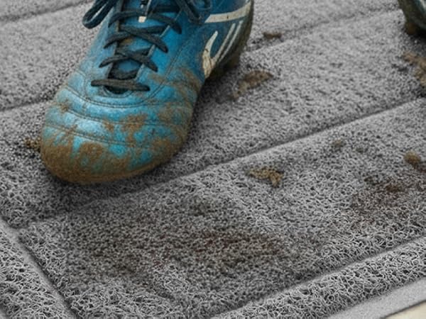 muddy boots walking across absorbent gray doormat