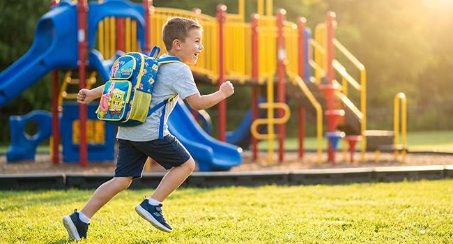 Kid wearing backpack running at playground