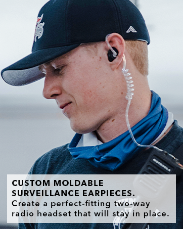 Man wearing our +Isolation Surveillance radio earpiece connected to a radio kit as a 2-way headset.