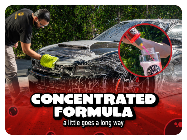 Hand sets Maxi Suds II Cherry shampoo bottle on a glossy orange car hood with strong reflection