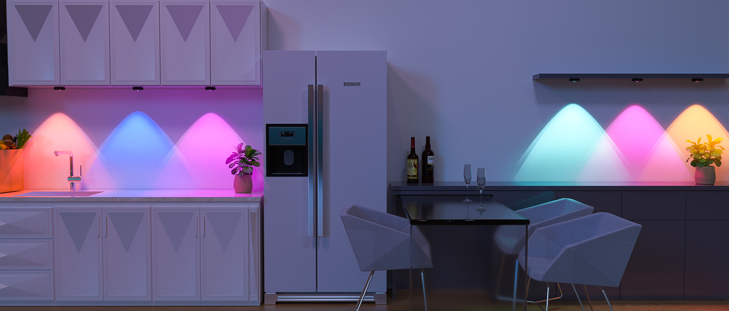 Modern kitchen interior with white cabinets illuminated by colorful LED accent lighting creating pink and blue gradient effects along the walls.