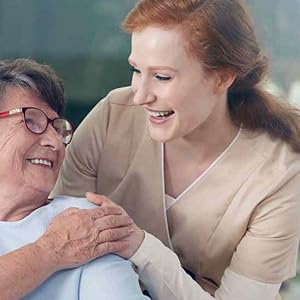 A nurse and elderly patient smiling