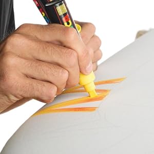 Drawing with a yellow posca marker on a white surface