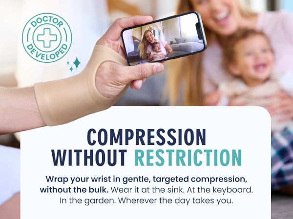 hand wearing wrist compression brace holding phone showing carpal tunnel brace for daily tasks