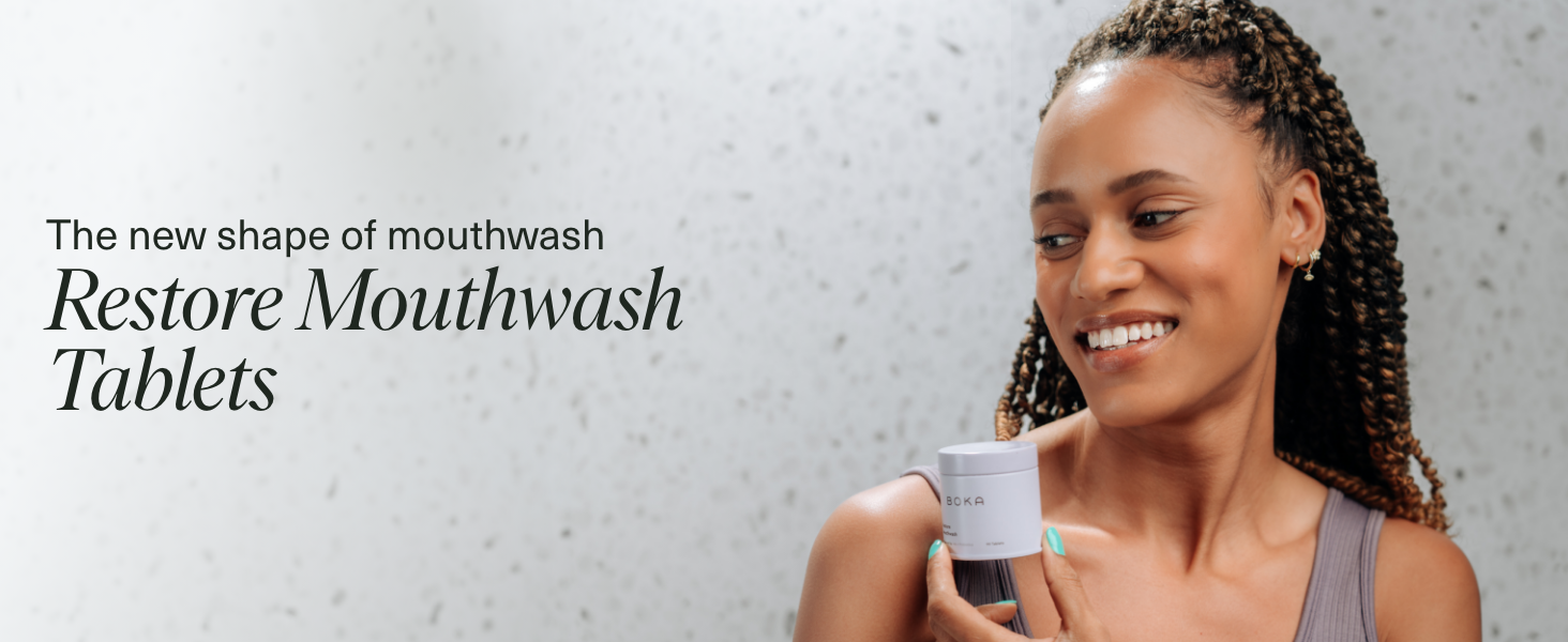 Woman using Restore Mouthwash Tablets 2-Pack