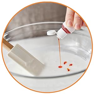 Person adding food coloring
