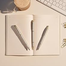 Three Parker IM Monochrome ballpoint pens on notebook