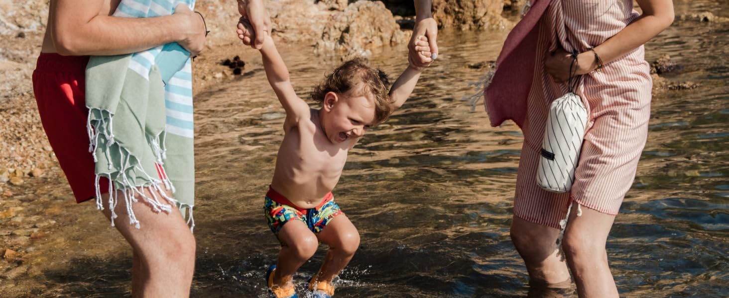 a boy is having a good time at the beach
