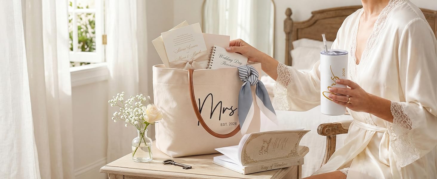 Bride in silk robe with coffee and Mrs Est 2026 tote bag containing wedding day essentials.