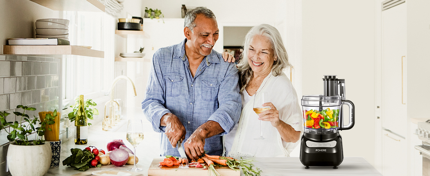 a couple cutting vegetables in the kitchen