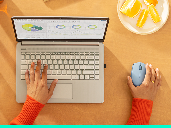 a woman working on a laptop using m170 wireless blue gray mouse