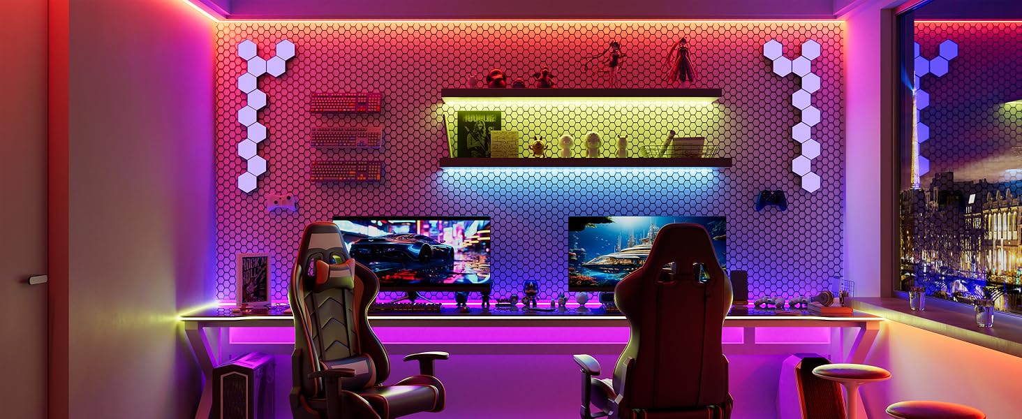 Modern gaming setup with colorful LED lighting, featuring racing-style chairs, multiple monitors, and a decorative hexagonal wall panel background. The room has a vibrant, futuristic ambiance.