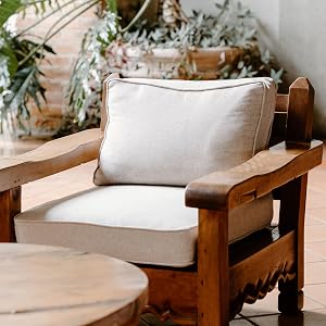 Wooden char with upholstered cushions.