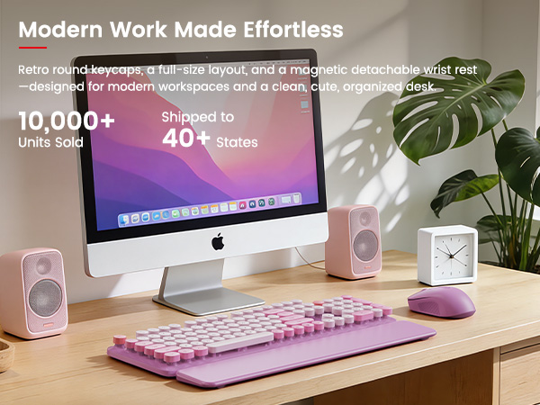 Lavender purple wireless keyboard and mouse with magnetic wrist rest on tidy desk beside Computer.