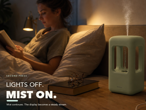 WINBEN humidifier with all lights off, visible mist and a steady internal water stream at night