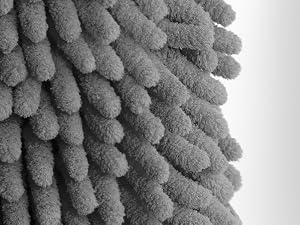 Extreme close-up of gray microfiber textile material showing dense, fluffy loops in a plush pattern against white background.