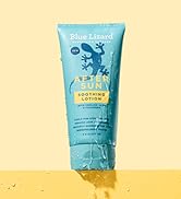 bottle of blue lizard after sun soothing lotion on a yellow ledge with water falling over it